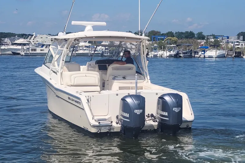 Slide: The Image of 2016 Grady-White Freedom 335 boat with twin Yamaha engines on the water. - 2
