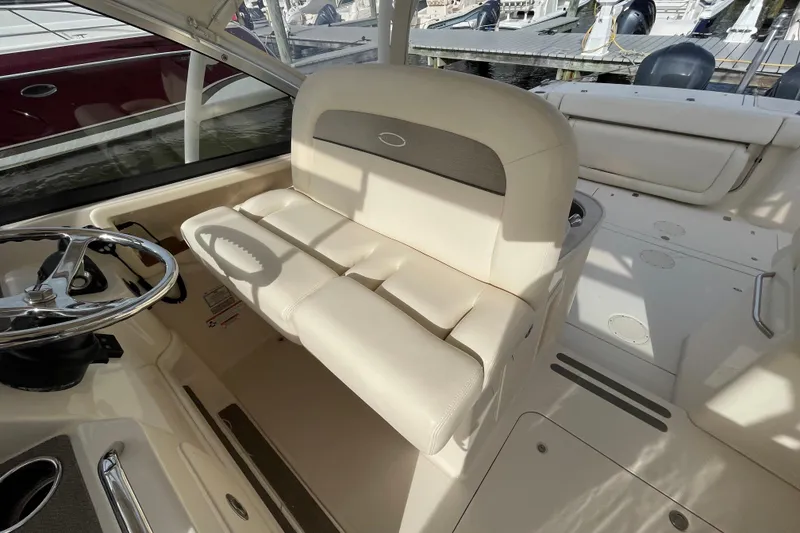Slide: The Image of 2016 Grady-White Freedom 335 boat interior with steering wheel and cushioned seating. - 20