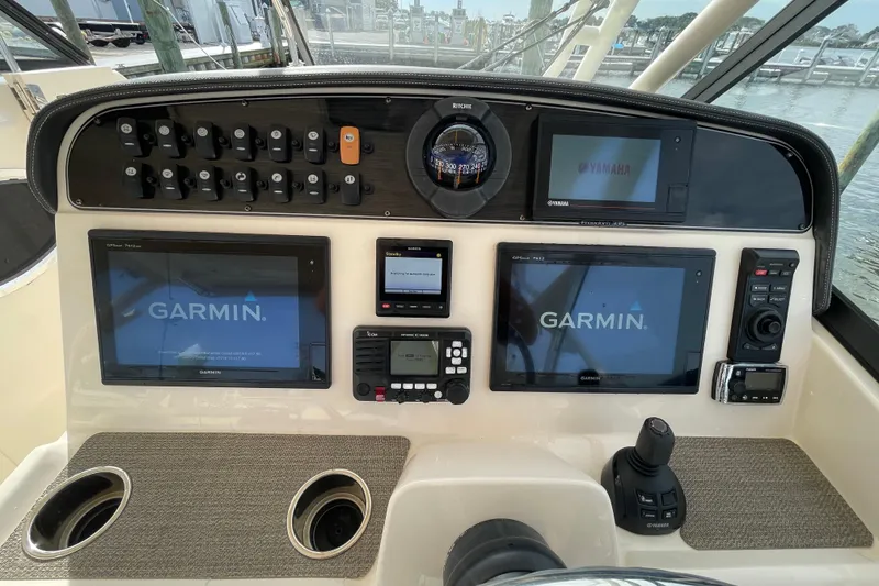 Slide: The Image of Control panel of 2016 Grady-White Freedom 335 boat with Garmin displays and navigation instruments. - 21