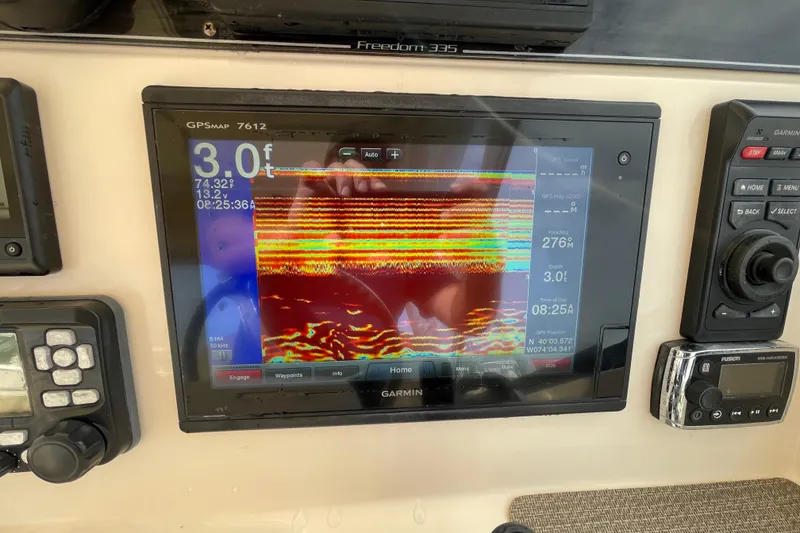 Slide: The Image of Garmin GPS display on 2016 Grady-White Freedom 335 boat dashboard. - 23
