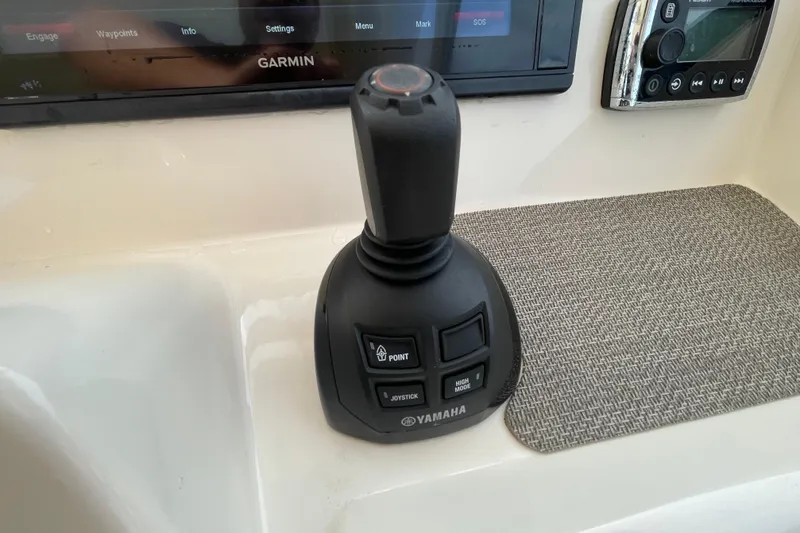 Slide: The Image of Yamaha joystick control on 2016 Grady-White Freedom 335 boat dashboard with Garmin display. - 27