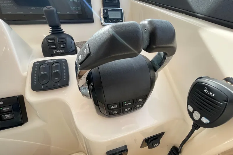 Slide: The Image of Control panel of 2016 Grady-White Freedom 335 boat with throttle and communication devices. - 29