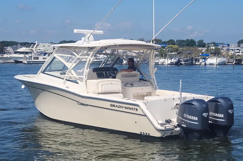 Slide: The Image of 2016 Grady-White Freedom 335 boat with Yamaha engines on a calm marina. - 3