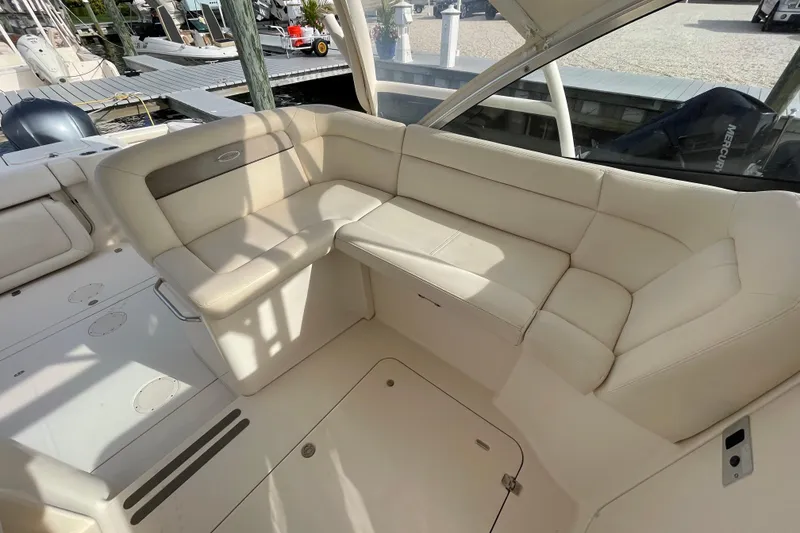 Slide: The Image of 2016 Grady-White Freedom 335 boat interior with beige seating and dock view. - 30