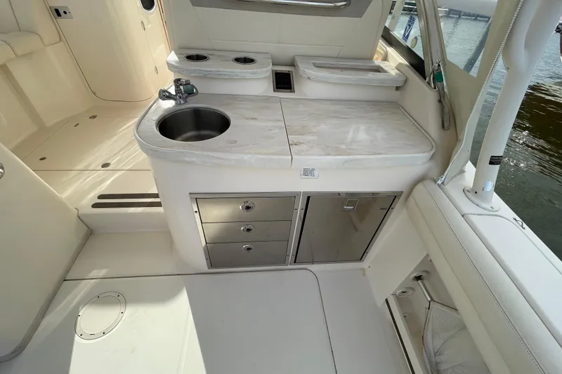 Slide: The Image of 2016 Grady-White Freedom 335 boat interior with sink, storage, and countertop. - 32