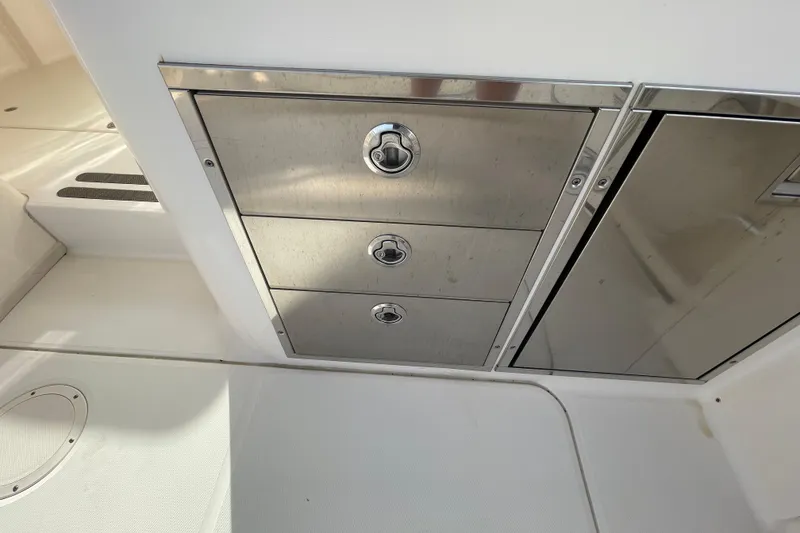 Slide: The Image of Stainless steel storage drawers on 2016 Grady-White Freedom 335 boat interior. - 34