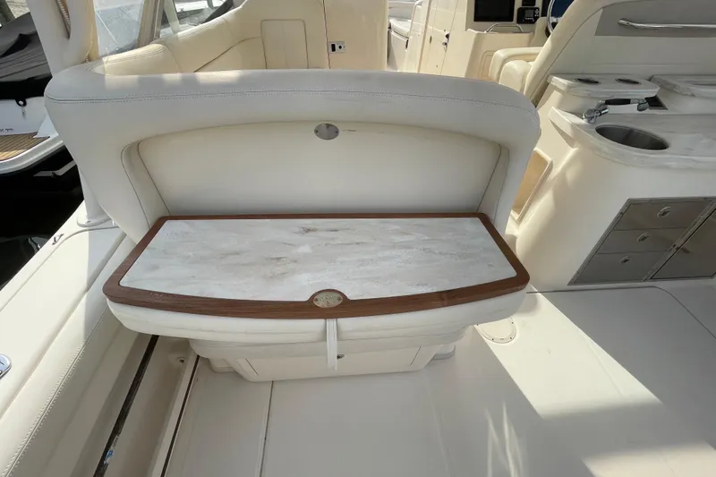 Slide: The Image of 2016 Grady-White Freedom 335 boat interior with white seating and wooden accents. - 36
