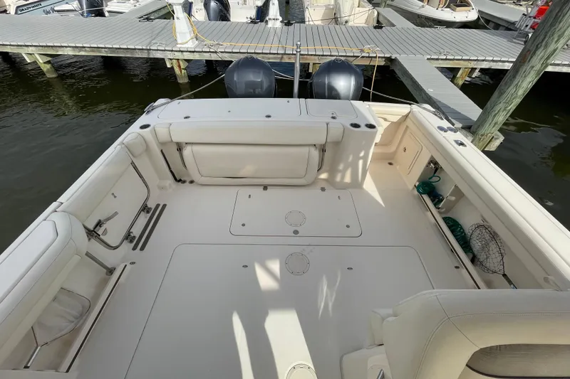Slide: The Image of 2016 Grady-White Freedom 335 boat interior with spacious deck and docked at marina. - 38