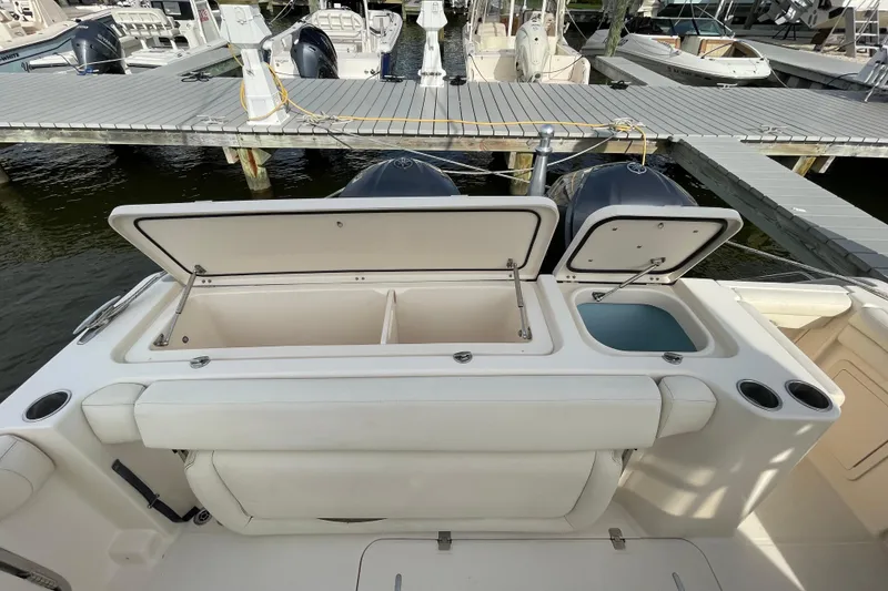 Slide: The Image of 2016 Grady-White Freedom 335 boat with open storage compartments at dock. - 39