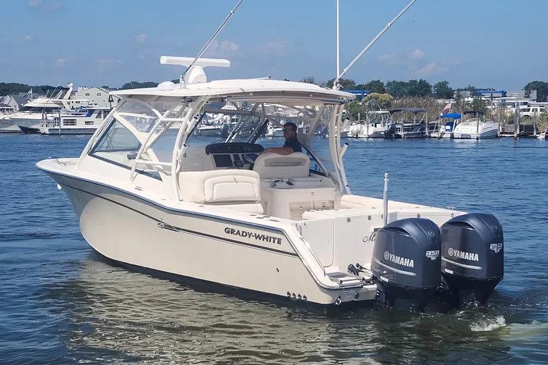 Slide: The Image of 2016 Grady-White Freedom 335 boat with twin Yamaha engines on the water. - 4
