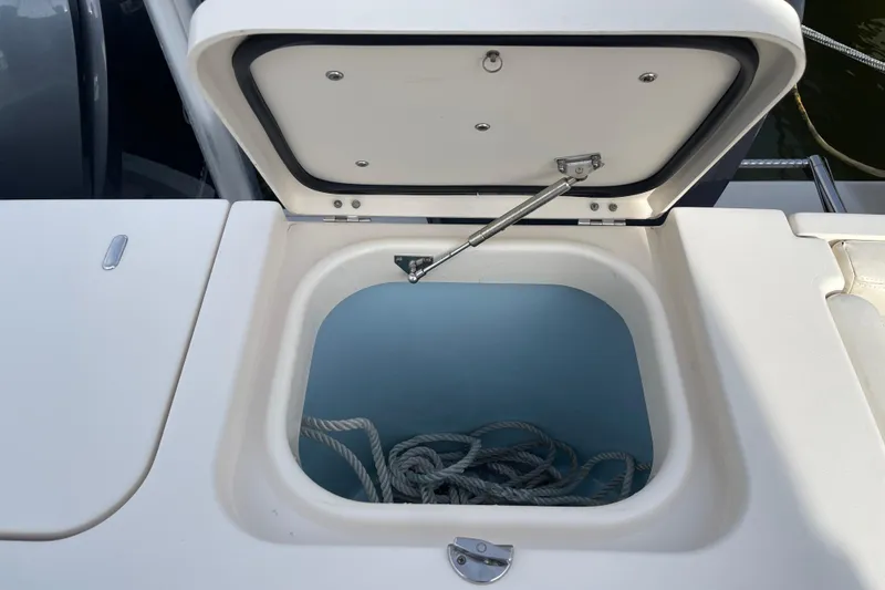 Slide: The Image of Open storage compartment on 2016 Grady-White Freedom 335 boat with rope inside. - 41