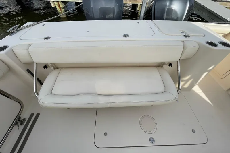 Slide: The Image of 2016 Grady-White Freedom 335 boat with white cushioned seating and dual outboard motors. - 43
