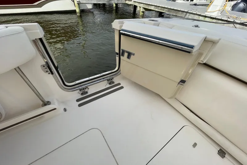 Slide: The Image of 2016 Grady-White Freedom 335 boat interior, open transom door, dockside view. - 45