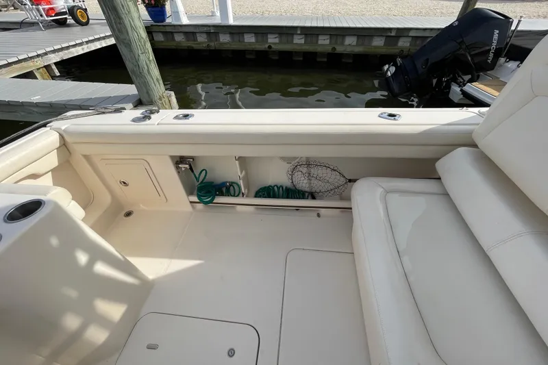 Slide: The Image of 2016 Grady-White Freedom 335 boat interior with storage compartment and seating. - 46