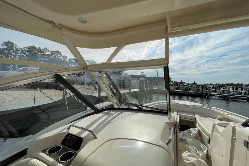 Slide: The Image of 2016 Grady-White Freedom 335 boat interior with marina view, clear skies, and docked boats. - 49