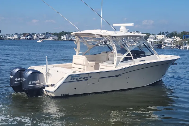 Slide: The Image of 2016 Grady-White Freedom 335 boat with twin Yamaha engines on a calm waterway. - 5