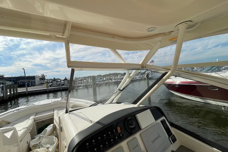 Slide: The Image of 2016 Grady-White Freedom 335 boat interior with marina view and clear sky. - 50