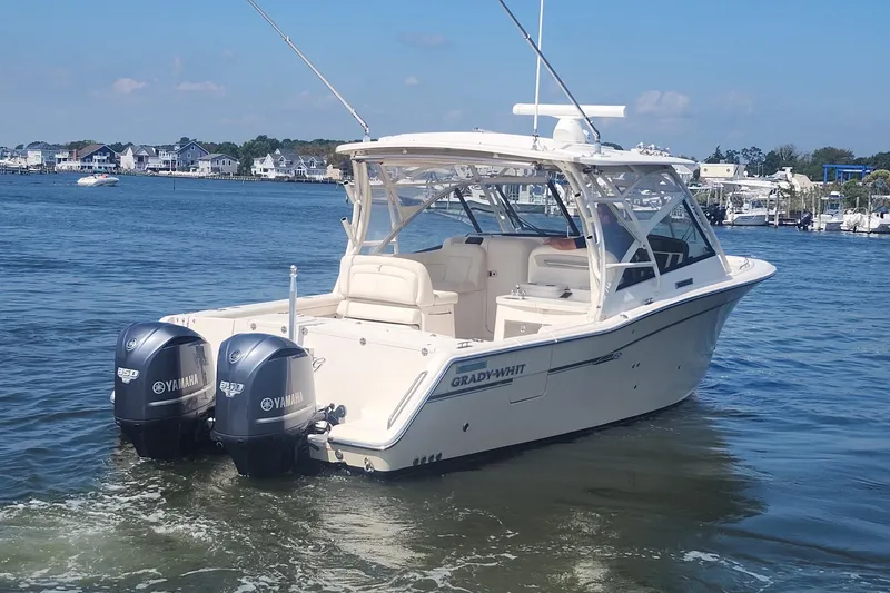 Slide: The Image of 2016 Grady-White Freedom 335 boat with twin Yamaha engines on a calm waterway. - 6