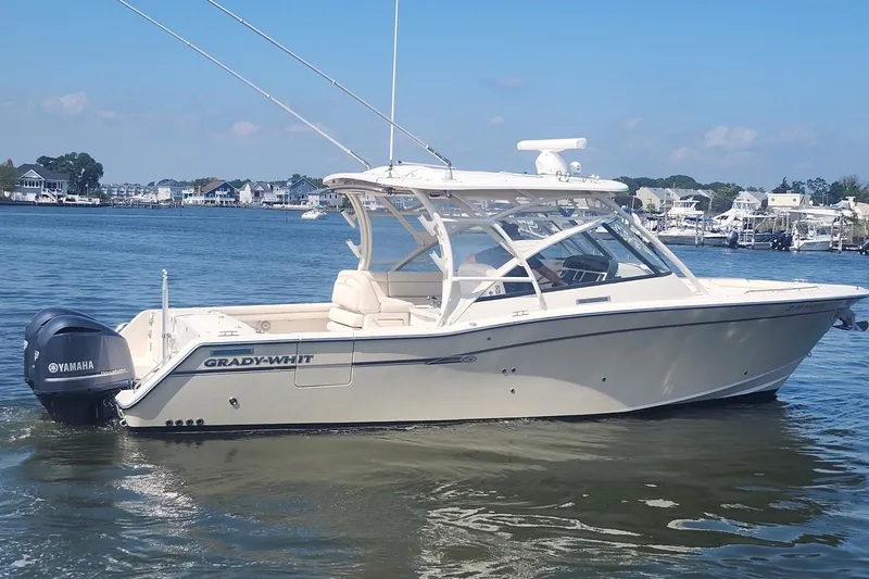 Slide: The Image of 2016 Grady-White Freedom 335 boat on calm water, featuring Yamaha engines. - 7