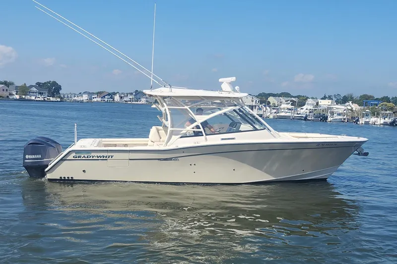 Slide: The Image of 2016 Grady-White Freedom 335 boat on calm water, with Yamaha outboard motor. - 8