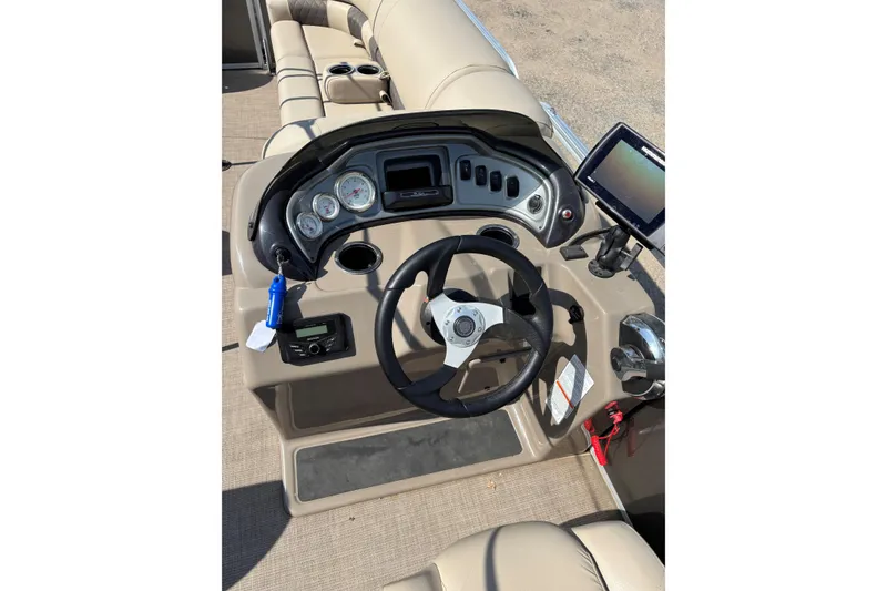 Slide: The Image of 2022 Sun Tracker Party Barge 20 DLX dashboard with steering wheel and controls. - 14