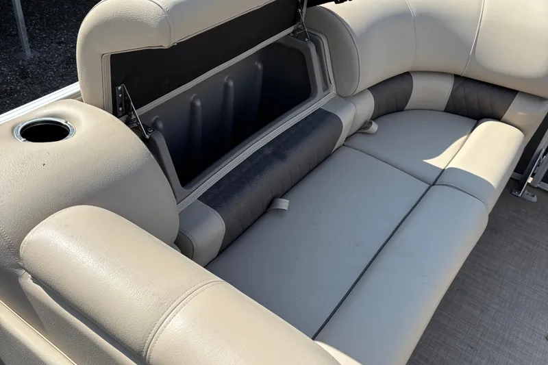 Slide: The Image of 2022 Sun Tracker Party Barge 20 DLX interior seating with storage compartment. - 19