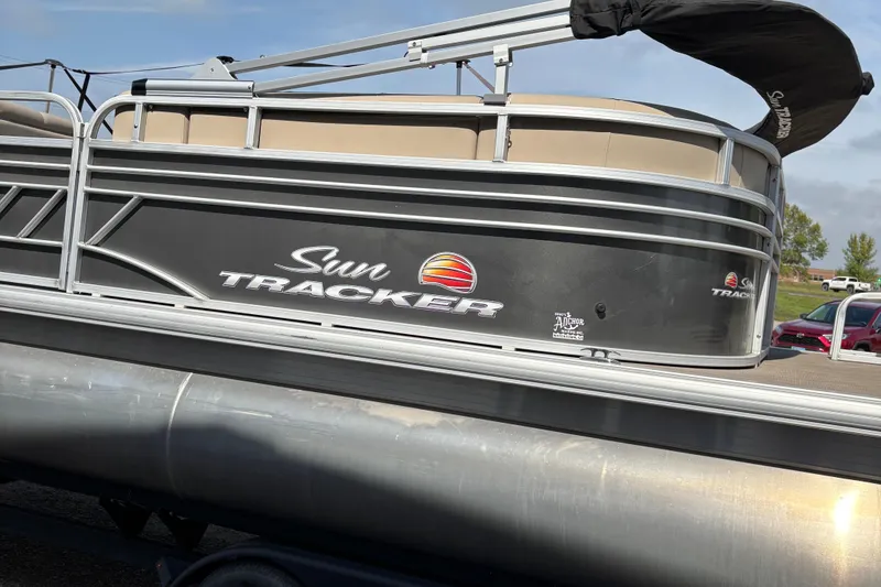 Slide: The Image of 2022 Sun Tracker Party Barge 20 DLX pontoon boat on trailer, side view. - 2