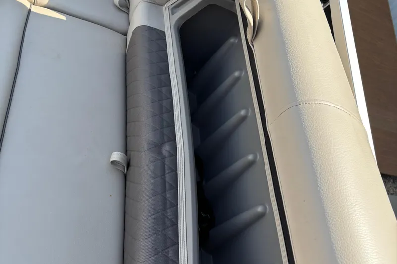 Slide: The Image of 2022 Sun Tracker Party Barge 20 DLX storage compartment with cushioned seating. - 20