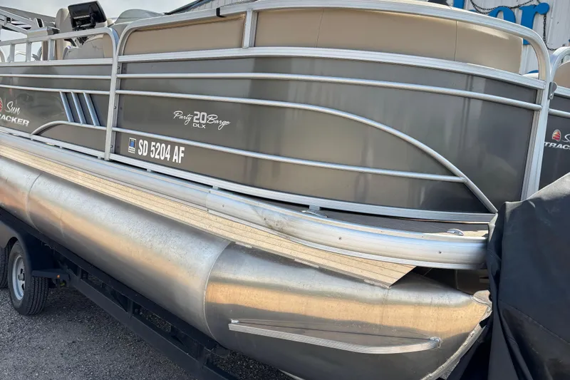 Slide: The Image of 2022 Sun Tracker Party Barge 20 DLX pontoon boat on trailer, side view. - 4