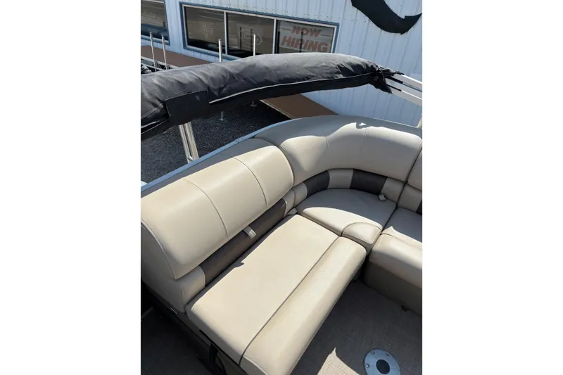 Slide: The Image of 2022 Sun Tracker Party Barge 20 DLX with beige seating and black canopy. - 9