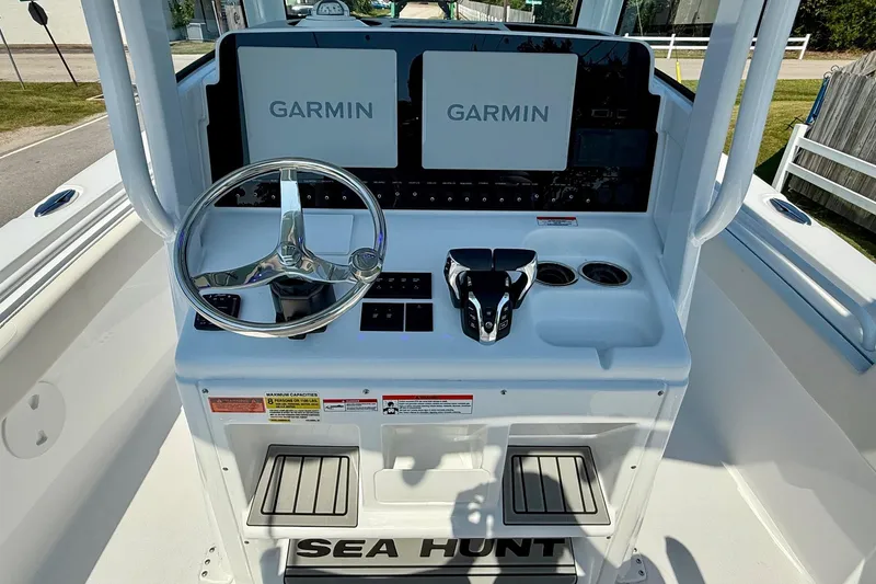 Slide: The Image of 2026 Sea Hunt Gamefish 25 helm with dual Garmin displays and steering wheel. - 11