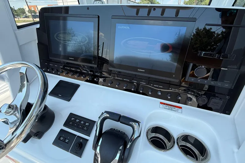 Slide: The Image of 2026 Sea Hunt Gamefish 25 dashboard with Garmin displays and controls. - 19