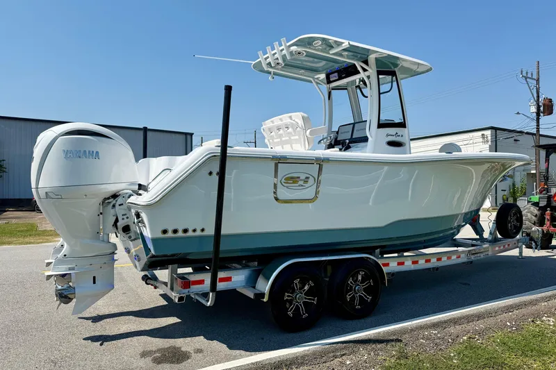 Slide: The Image of 2026 Sea Hunt Gamefish 25 boat on trailer, featuring Yamaha outboard motor. - 4