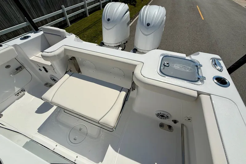 Slide: The Image of 2026 Sea Hunt Gamefish 25 boat interior with seating and dual outboard motors. - 7