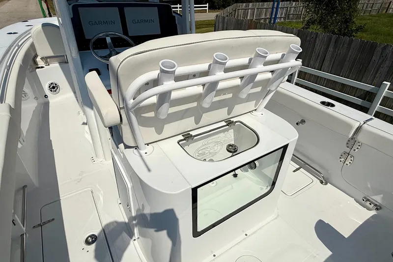 Slide: The Image of 2026 Sea Hunt Gamefish 25 boat interior with rod holders and Garmin displays. - 9