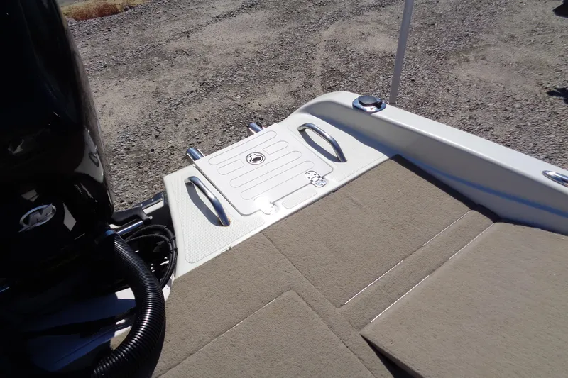 Slide: The Image of 2011 Nitro 290 boat deck with carpeted surface and storage hatch. - 15