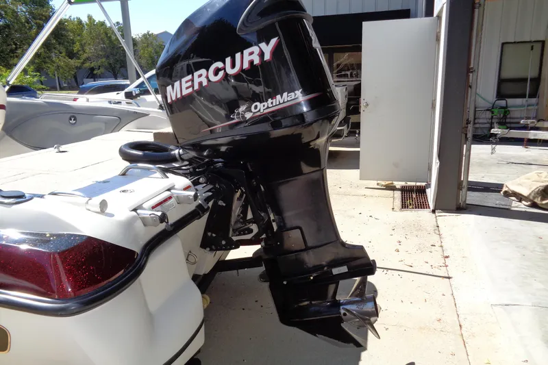 Slide: The Image of 2011 Nitro 290 boat with Mercury OptiMax outboard motor in a sunny outdoor setting. - 21