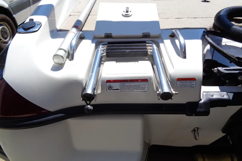 Slide: The Image of 2011 Nitro 290 boat stern with ladder and safety warnings. - 26