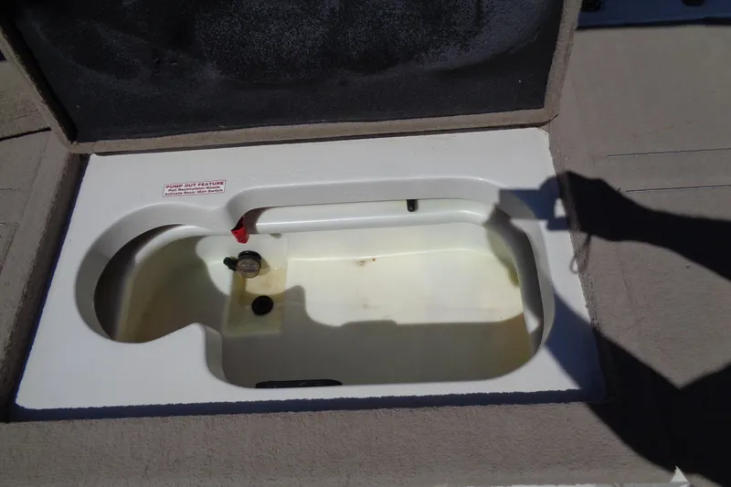 Slide: The Image of Open storage compartment in 2011 Nitro 290 boat, featuring pump-out feature. - 27