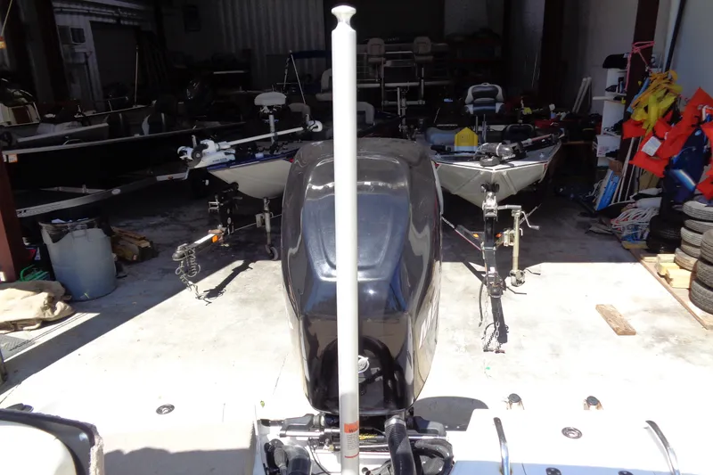 Slide: The Image of 2011 Nitro 290 boat in storage with visible outboard motor and equipment. - 29