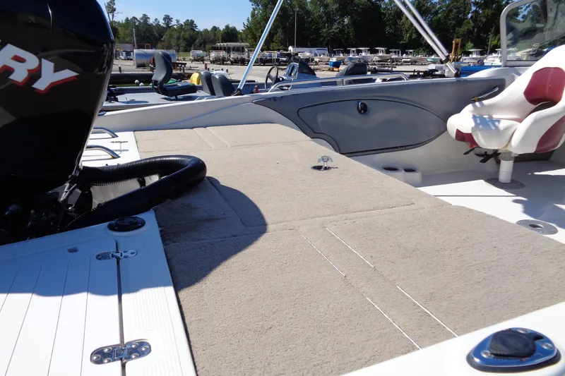 Slide: The Image of 2011 Nitro 290 boat with spacious deck and comfortable seating in a marina setting. - 9