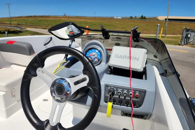 Slide: The Image of Steering wheel and dashboard of 2022 Tahoe T18 boat with Garmin navigation system. - 11
