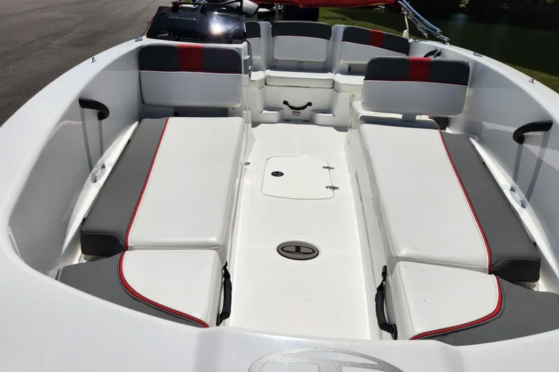 Slide: The Image of 2022 Tahoe T18 boat interior with white and gray seating, red accents, and storage compartments. - 8
