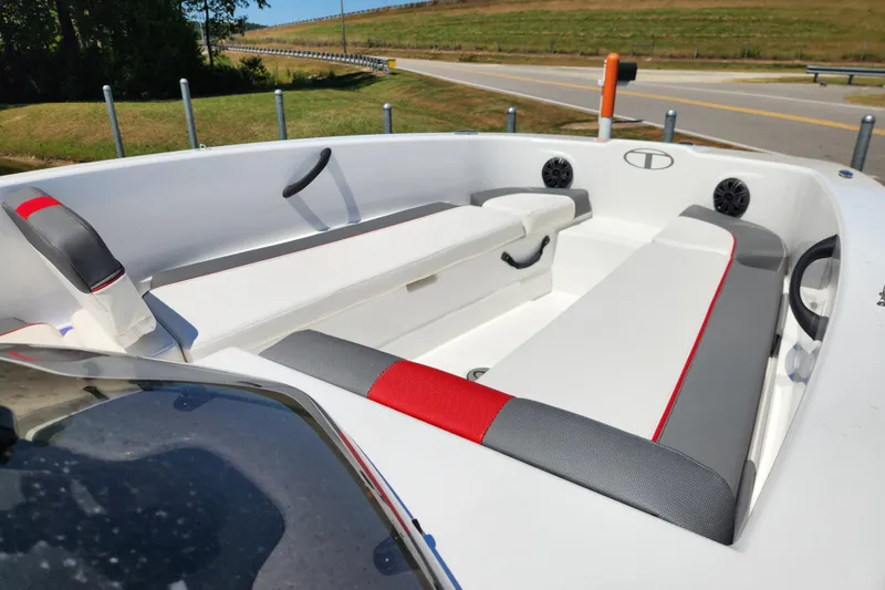 Slide: The Image of 2022 Tahoe T18 boat interior with white and gray seating, red accents, and speakers. - 9