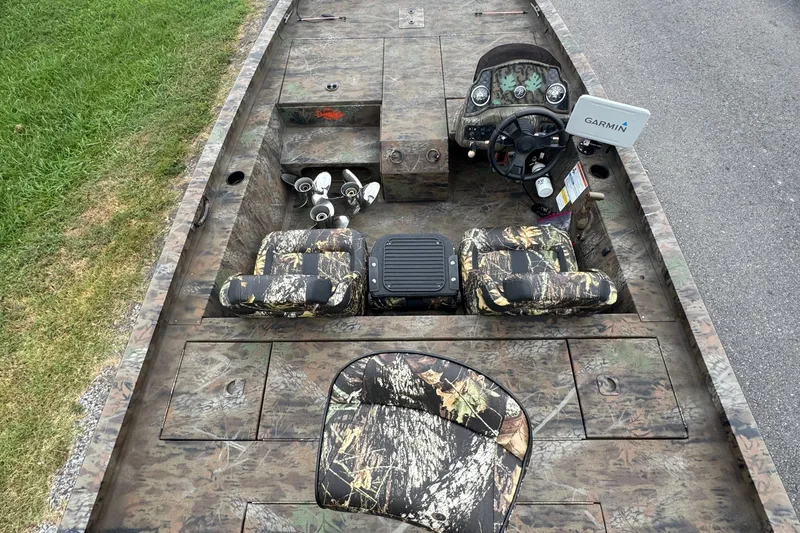 Slide: The Image of 2021 G3 Sportsman 1710 Camo boat interior with camouflage seats and Garmin navigation. - 3