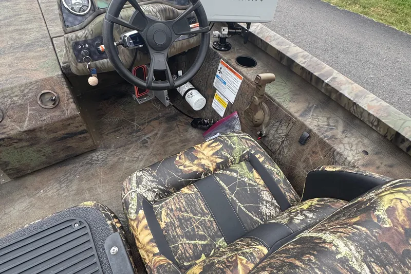 Slide: The Image of 2021 G3 Sportsman 1710 Camo boat interior with camouflage seats and steering wheel. - 5