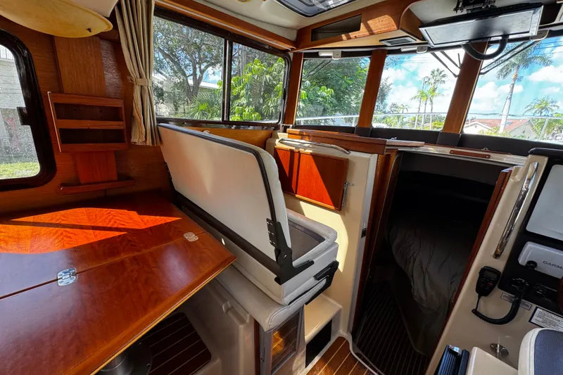 Slide: The Image of Interior of 2014 Ranger Tugs R-31 CB boat with wood finishes and seating area. - 6
