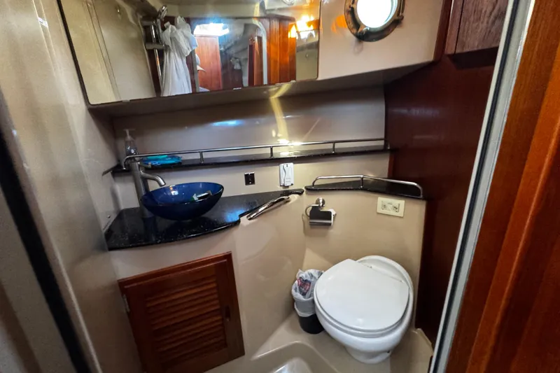 Slide: The Image of 2014 Ranger Tugs R-31 CB bathroom with modern sink, toilet, and porthole window. - 8