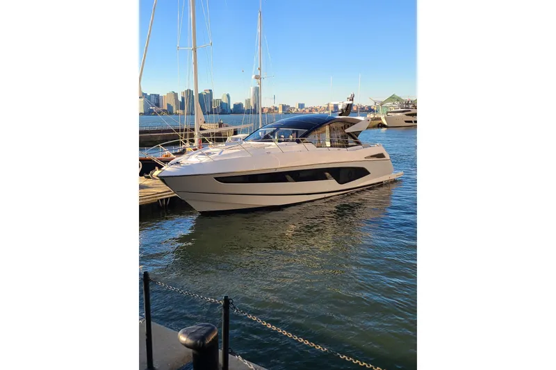 The Image of 2021 Sunseeker 60 Evo yacht cruising on open water under a clear blue sky. - 0