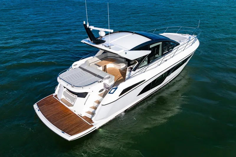 Slide: The Image of 2021 Sunseeker 60 Evo yacht cruising on open water, showcasing sleek design and luxury features. - 10